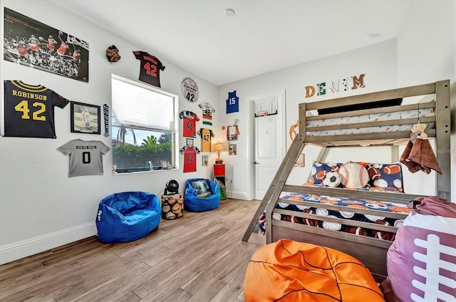 bedroom with hardwood / wood-style flooring