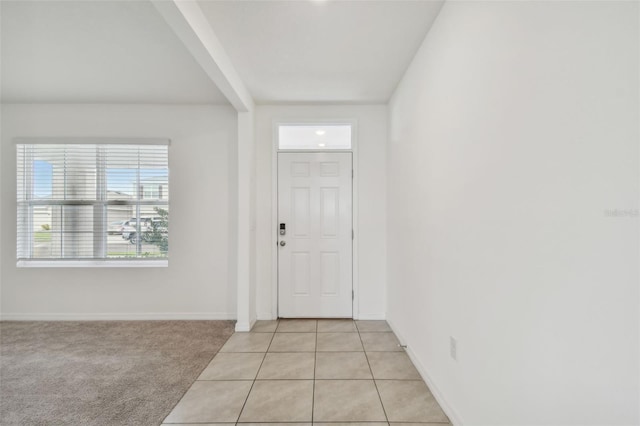 entryway featuring light colored carpet