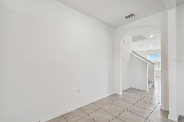 hall with light tile patterned floors