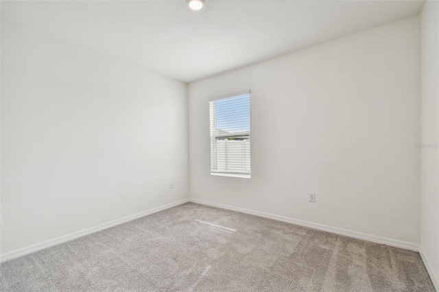 unfurnished room with light carpet