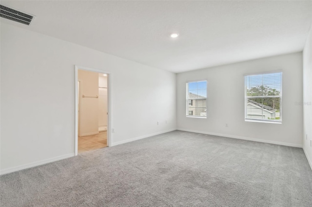 empty room featuring light carpet