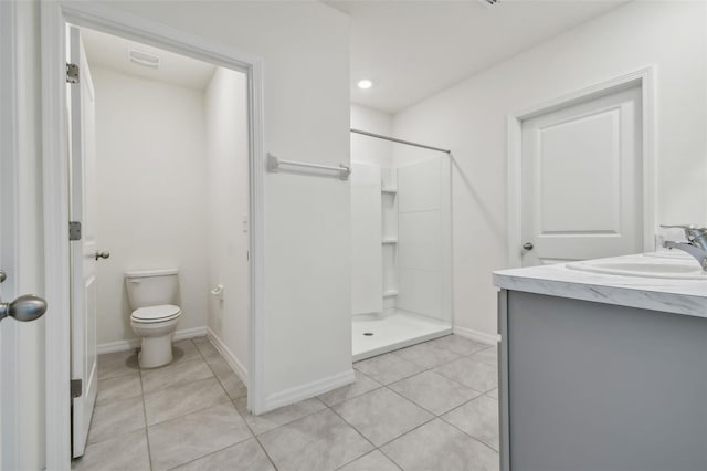 bathroom featuring tile patterned floors, vanity, toilet, and walk in shower