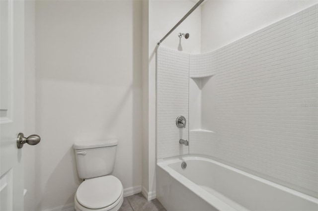 bathroom with tile patterned floors, toilet, and shower / washtub combination