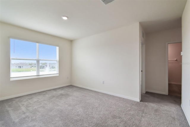 unfurnished room with light colored carpet