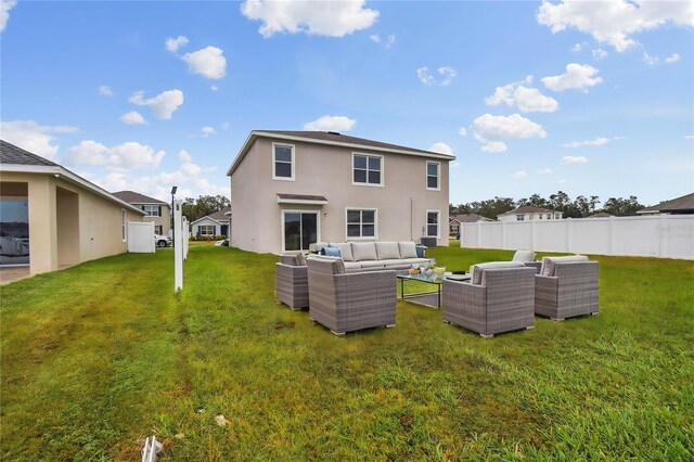 rear view of property featuring a lawn and an outdoor hangout area