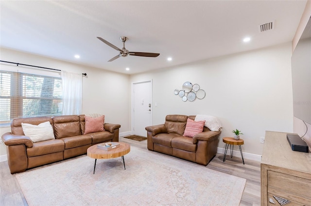 living room with ceiling fan and light hardwood / wood-style floors