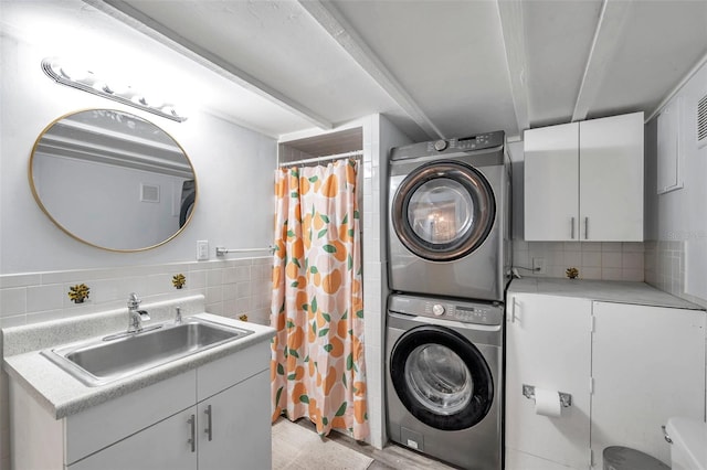 clothes washing area with sink and stacked washer / dryer