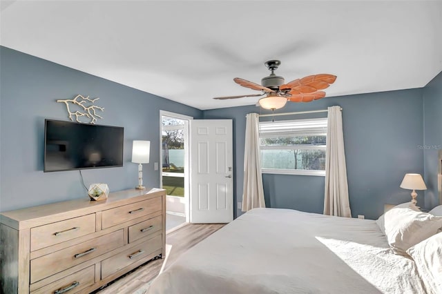 bedroom with light hardwood / wood-style floors, multiple windows, and ceiling fan