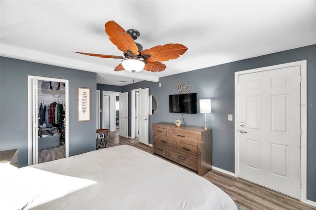 bedroom featuring ceiling fan, wood-type flooring, and a closet