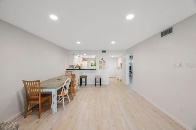 dining area with light hardwood / wood-style flooring