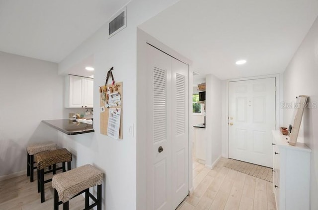 corridor featuring light hardwood / wood-style floors