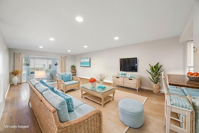 living area featuring recessed lighting, wood finished floors, and baseboards