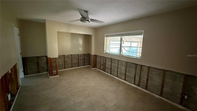 basement with ceiling fan