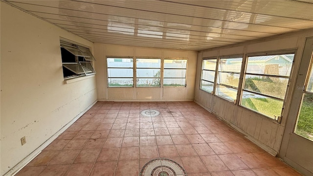 unfurnished sunroom featuring vaulted ceiling