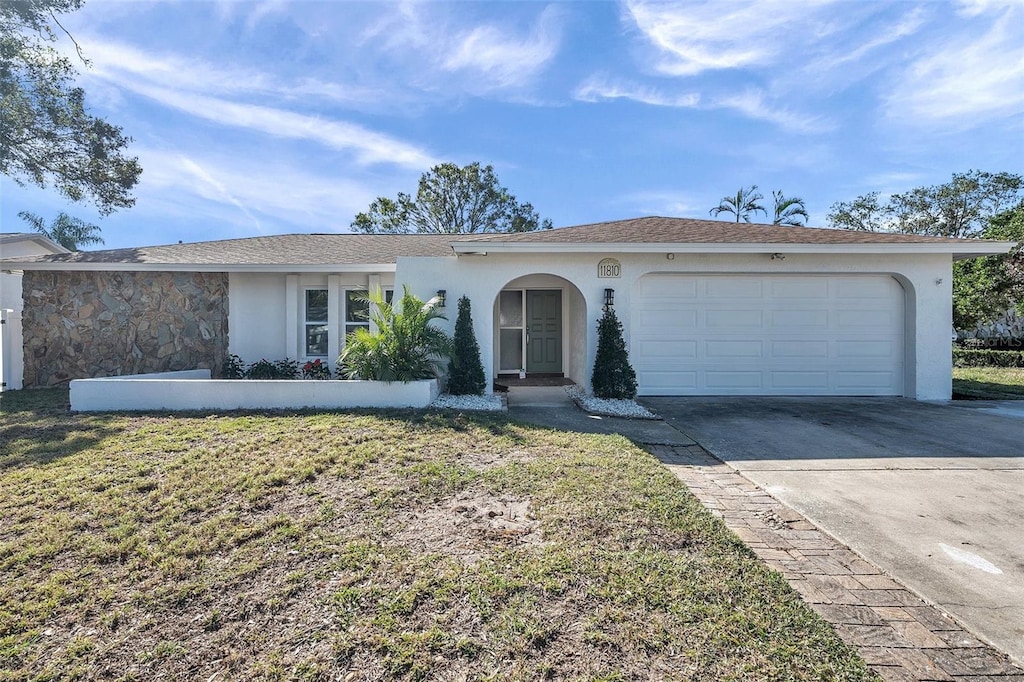 view of front of property with a front yard and a garage