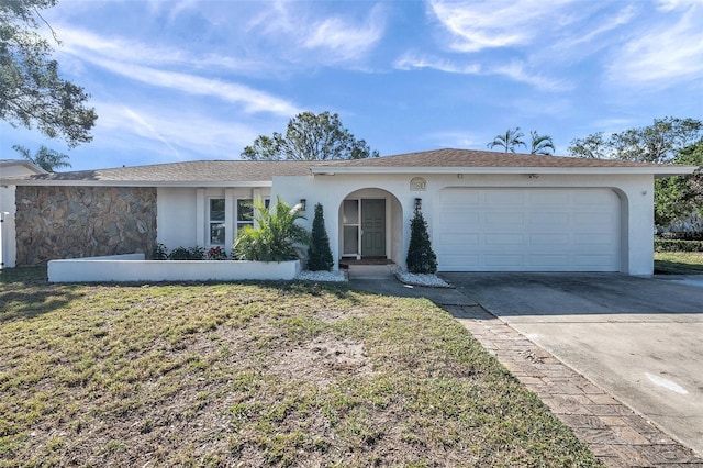 view of front of property with a front yard and a garage