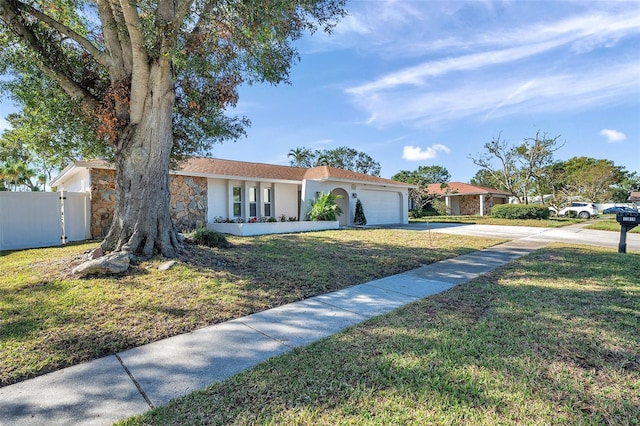 single story home with a garage and a front lawn