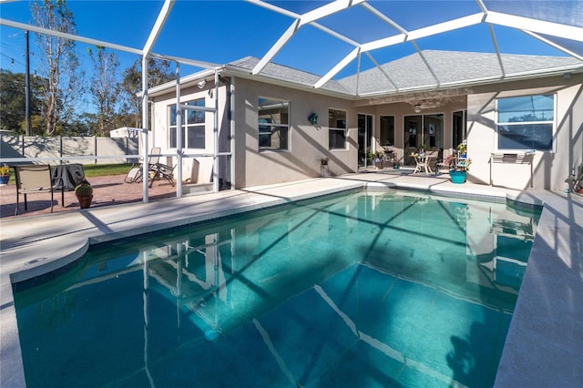 view of pool featuring a patio, ceiling fan, and a lanai