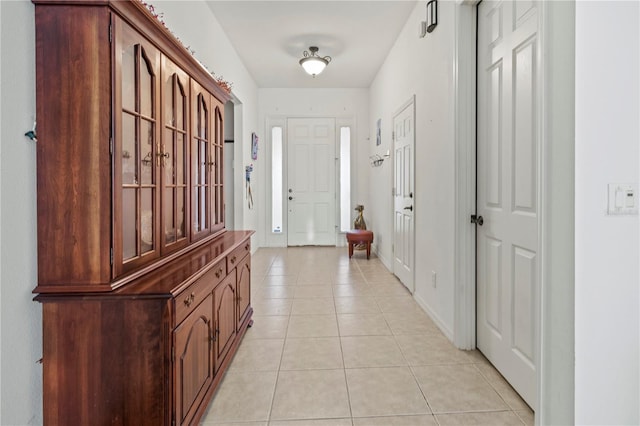 interior space with baseboards and light tile patterned flooring