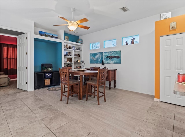 dining room with a ceiling fan, visible vents, and baseboards