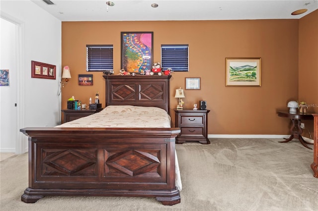 bedroom with light carpet, visible vents, and baseboards