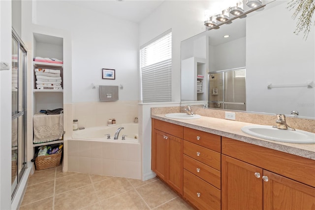 full bath with double vanity, a sink, a bath, and tile patterned floors