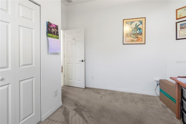 bedroom featuring baseboards and light colored carpet