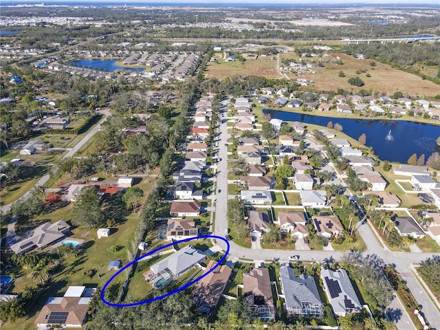 bird's eye view featuring a water view and a residential view