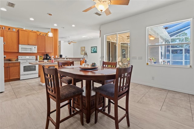 dining room with a ceiling fan, recessed lighting, visible vents, and baseboards