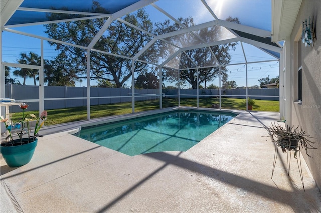 view of swimming pool featuring glass enclosure, a fenced backyard, and a patio