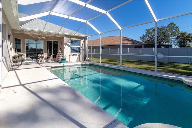 view of swimming pool featuring glass enclosure, a patio, fence, and a fenced in pool