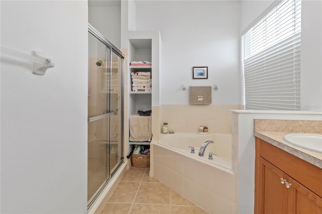 bathroom featuring a garden tub, a shower stall, vanity, and tile patterned floors