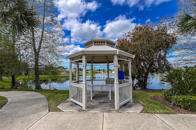 exterior space with a gazebo, a yard, and a water view