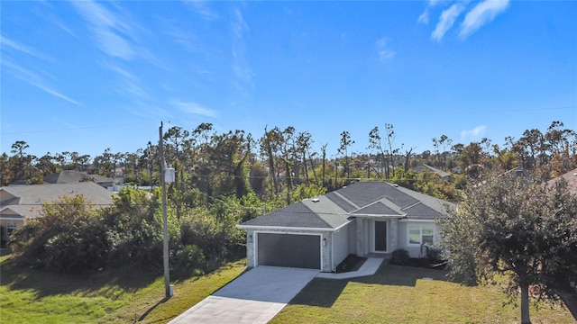 view of front of home with a garage and a front lawn