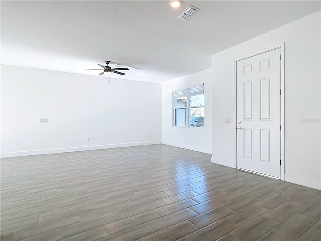 spare room featuring dark hardwood / wood-style flooring and ceiling fan