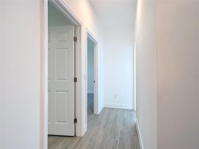 hallway with light hardwood / wood-style flooring