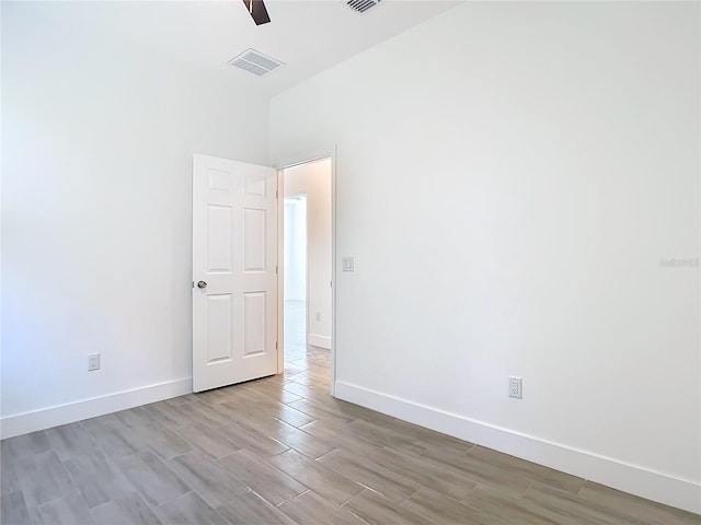 empty room featuring ceiling fan and light wood-type flooring