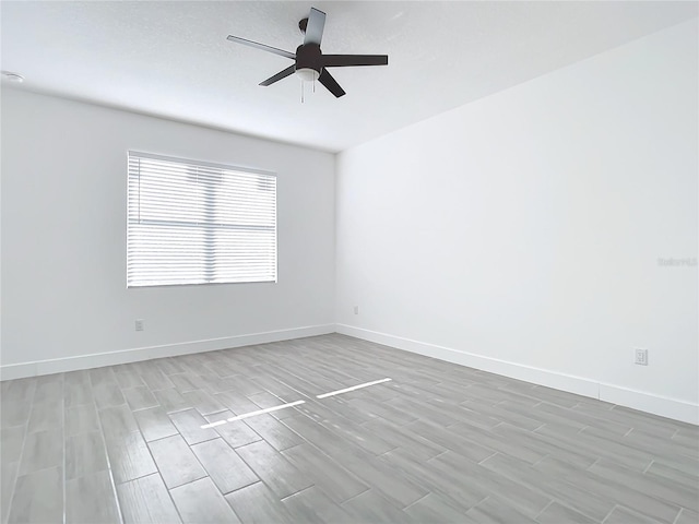 unfurnished room with light hardwood / wood-style flooring and ceiling fan