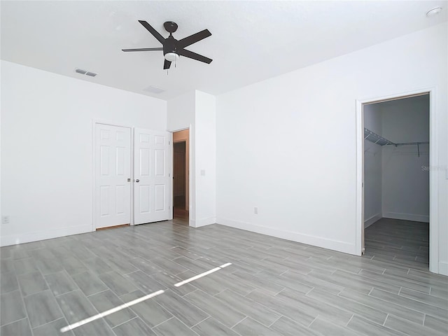 unfurnished room featuring light hardwood / wood-style floors and ceiling fan