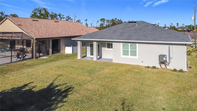 back of house featuring a lanai, a yard, a patio, and central AC unit