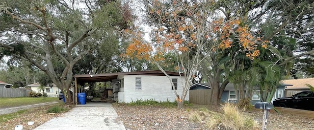 view of side of home with a carport