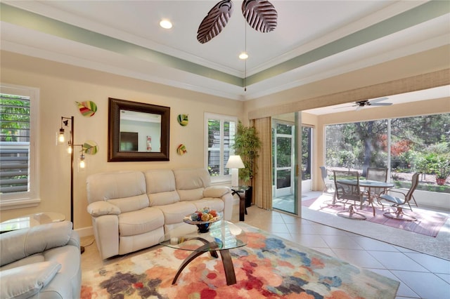 living room featuring ceiling fan, light tile patterned floors, and ornamental molding