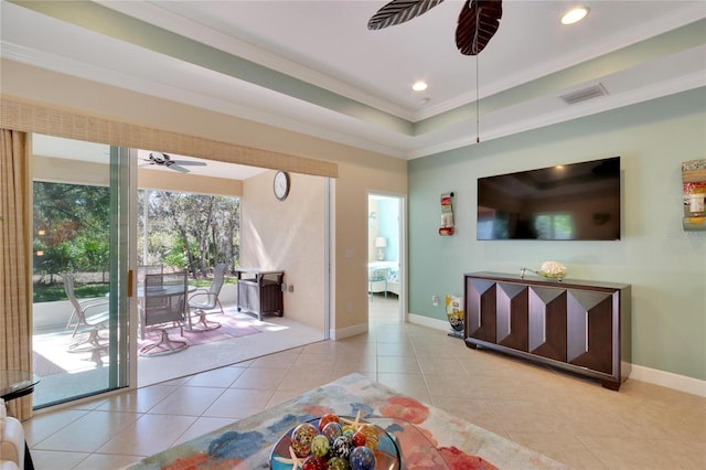 tiled living room featuring ceiling fan and crown molding