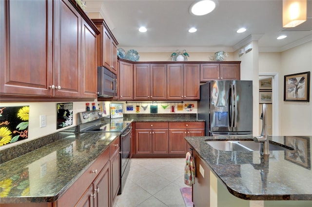 kitchen featuring sink, dark stone countertops, light tile patterned floors, ornamental molding, and appliances with stainless steel finishes