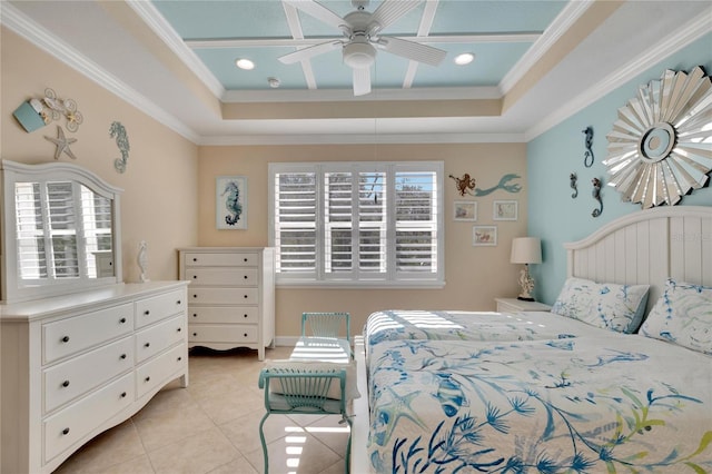 bedroom with light tile patterned floors, a tray ceiling, ceiling fan, and crown molding