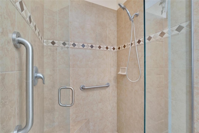 bathroom with a shower with shower door