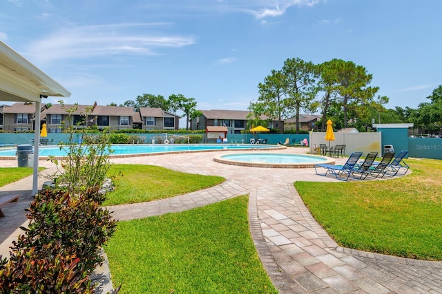 view of pool with a yard and a patio