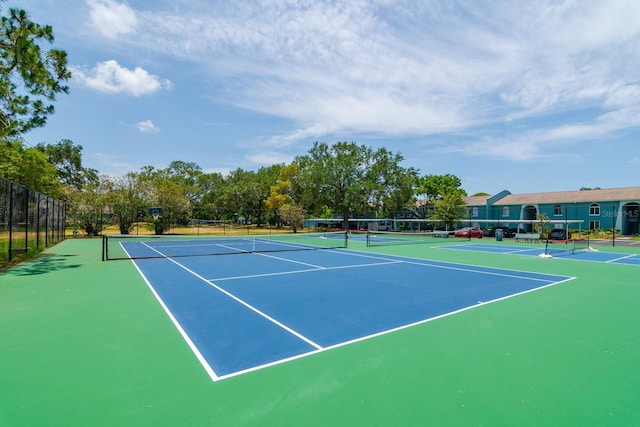 view of tennis court featuring basketball hoop