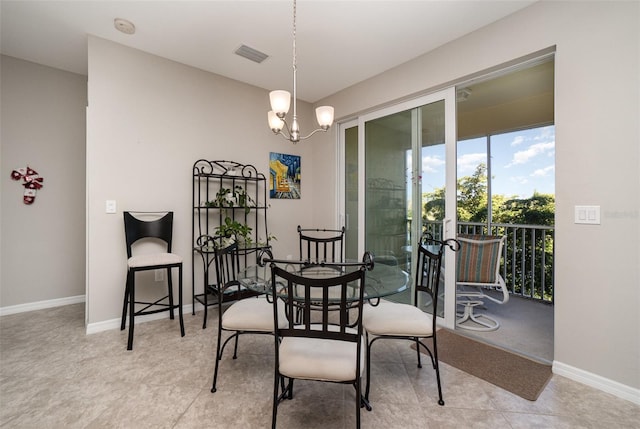 dining space with an inviting chandelier