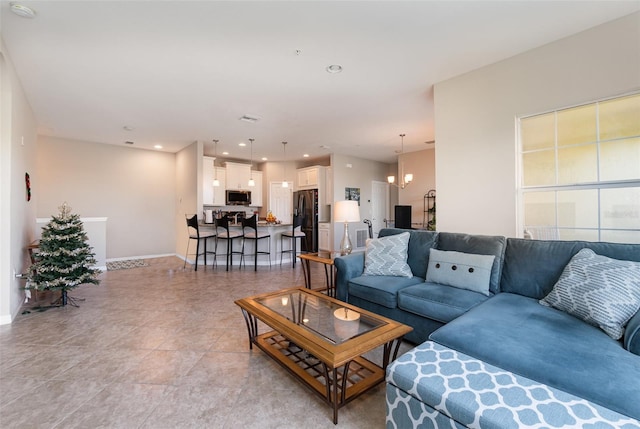 living room featuring a notable chandelier